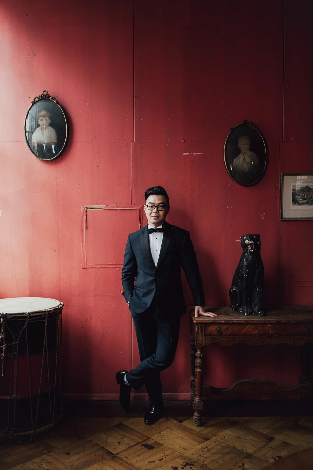 Groom portrait in a red room